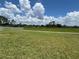 Backyard with manicured lawn with a fence and view of a scenic green space at 464 Talisi Loop, St Cloud, FL 34771