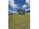 Spacious backyard featuring a two-story home with sliding doors leading to a patio at 464 Talisi Loop, St Cloud, FL 34771