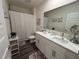 Bright bathroom with double vanity, large mirror, and modern fixtures at 464 Talisi Loop, St Cloud, FL 34771