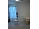Office space with glass desk and white stool next to a window with a sheer curtain at 464 Talisi Loop, St Cloud, FL 34771