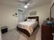 Cozy bedroom with decorative pillows, ceiling fan, and themed decor at 464 Talisi Loop, St Cloud, FL 34771