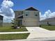 Charming two-story home with a manicured lawn, two-car garage, and tasteful landscaping at 464 Talisi Loop, St Cloud, FL 34771