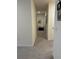 Well-lit hallway with neutral carpet leading to various rooms and decor at 464 Talisi Loop, St Cloud, FL 34771