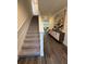 Hallway with carpeted stairs, modern decor, and views into a light-filled living space at 464 Talisi Loop, St Cloud, FL 34771