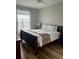 Inviting bedroom with a comfortable bed, soft lighting, and hardwood floors at 4862 Cayview Ave # 40409, Orlando, FL 32819