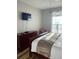 Cozy bedroom featuring a TV, dresser, and comfortable bed with natural light from the window at 4862 Cayview Ave # 40409, Orlando, FL 32819