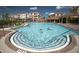 Luxurious community pool area with palm trees and comfortable lounge chairs under a bright, cloudy sky at 4862 Cayview Ave # 40409, Orlando, FL 32819