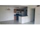 A kitchen with a breakfast bar and tile floors, featuring wood cabinets and stainless steel appliances at 5287 Images Cir # 307, Kissimmee, FL 34746