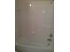 Clean and functional white tiled tub and shower combination at 6137 Metrowest Blvd # 308, Orlando, FL 32835