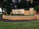 Well-maintained community sign surrounded by lush landscaping at 6137 Metrowest Blvd # 308, Orlando, FL 32835