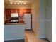 Cozy kitchen features white appliances and wood cabinets at 6137 Metrowest Blvd # 308, Orlando, FL 32835