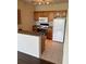 View of the kitchen with tile floor, cabinets, white appliances, and breakfast bar at 6137 Metrowest Blvd # 308, Orlando, FL 32835