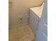 The laundry room features tile floors and a white clothes dryer at 6137 Metrowest Blvd # 308, Orlando, FL 32835