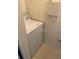 The laundry room features tile floors and a white clothes washing machine at 6137 Metrowest Blvd # 308, Orlando, FL 32835
