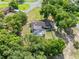 Bird's eye view shows home featuring a pool and large fenced yard with plenty of privacy and trees at 6441 Nightwind Cir, Orlando, FL 32818