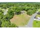 Aerial view of a home on a large lot surrounded by mature trees in a lush, green neighborhood at 6441 Nightwind Cir, Orlando, FL 32818