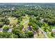 A birds-eye view of the neighborhood shows mature trees and sprawling lots at 6441 Nightwind Cir, Orlando, FL 32818