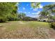 Expansive backyard featuring lush greenery and a screened-in patio for outdoor enjoyment at 6441 Nightwind Cir, Orlando, FL 32818