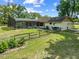 Expansive backyard featuring a screened pool, wood fence, and lush green grass at 6441 Nightwind Cir, Orlando, FL 32818