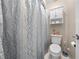 Standard bathroom features shower/tub combo with patterned curtain and toilet at 6441 Nightwind Cir, Orlando, FL 32818
