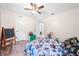 Well-lit bedroom with hardwood flooring, featuring a ceiling fan and access to other rooms at 6441 Nightwind Cir, Orlando, FL 32818