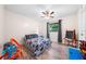 Comfortable bedroom featuring a ceiling fan, hardwood flooring, and a large window at 6441 Nightwind Cir, Orlando, FL 32818