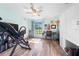 Bedroom featuring wood-look flooring, light blue paint scheme, ceiling fan and desk at 6441 Nightwind Cir, Orlando, FL 32818