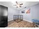Bedroom featuring a ceiling fan, wood-look flooring, and a pet kennel at 6441 Nightwind Cir, Orlando, FL 32818