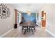 Dining room with a modern light fixture, accent wall, large window, and tile flooring at 6441 Nightwind Cir, Orlando, FL 32818