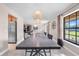 Dining room featuring modern light fixtures, a view of the exterior, and tile flooring at 6441 Nightwind Cir, Orlando, FL 32818