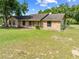 Charming single story home with a well maintained lawn, blue front door, and brick exterior at 6441 Nightwind Cir, Orlando, FL 32818