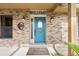 Close-up of the front door with decorative details, sconce lighting, and a 'Welcome' sign at 6441 Nightwind Cir, Orlando, FL 32818