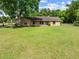 Charming single story home with a well maintained lawn, blue front door, and brick exterior at 6441 Nightwind Cir, Orlando, FL 32818
