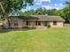 Charming single story home with a well maintained lawn, blue front door, and brick exterior at 6441 Nightwind Cir, Orlando, FL 32818