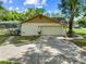 This home features a two car garage and long driveway and well manicured lawn at 6441 Nightwind Cir, Orlando, FL 32818
