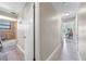 Hallway view toward a bathroom with shower and view to a room with a light blue paint scheme at 6441 Nightwind Cir, Orlando, FL 32818