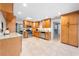 Bright kitchen boasts stainless steel appliances, wooden cabinets, and a view into the dining area and exterior at 6441 Nightwind Cir, Orlando, FL 32818