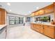 Bright eat-in kitchen area features cabinets, a window, tile flooring, and view of brick fireplace at 6441 Nightwind Cir, Orlando, FL 32818