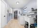 Efficient laundry room with ample storage, modern washer and dryer, and convenient sink at 6441 Nightwind Cir, Orlando, FL 32818