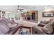 Cozy living room with a brick fireplace, ceiling fan, comfortable seating, and a glass coffee table at 6441 Nightwind Cir, Orlando, FL 32818