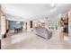 Open-concept living area with tile flooring, a brick fireplace, and views to dining and backyard through french doors at 6441 Nightwind Cir, Orlando, FL 32818