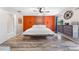 Spacious main bedroom features wood-look flooring, a ceiling fan, and an orange accent wall at 6441 Nightwind Cir, Orlando, FL 32818