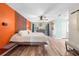 Spacious main bedroom features wood-look flooring, a ceiling fan, and an orange accent wall at 6441 Nightwind Cir, Orlando, FL 32818