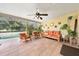 Relaxing screened-in patio with comfortable seating and views of the backyard pool at 6441 Nightwind Cir, Orlando, FL 32818