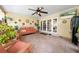 Inviting screened-in patio with a comfortable seating area and view of the backyard at 6441 Nightwind Cir, Orlando, FL 32818