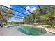 Beautiful in-ground screened pool with ample space for entertaining and relaxation in an outdoor living space at 6441 Nightwind Cir, Orlando, FL 32818