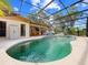 Inviting screened-in pool area featuring a spacious deck and lush landscaping, perfect for outdoor relaxation and entertainment at 6441 Nightwind Cir, Orlando, FL 32818