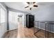 Versatile room with hardwood flooring and a secure storage cabinet at 6441 Nightwind Cir, Orlando, FL 32818