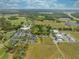 Panoramic aerial view of a community featuring a golf course and commercial areas at 7413 Bent Tree Loop, St Cloud, FL 34771