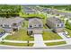 Aerial view of new home with fenced yard, front lawn and landscaping in residential neighborhood at 7413 Bent Tree Loop, St Cloud, FL 34771